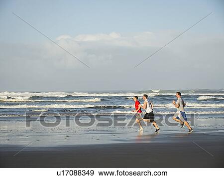 Men running on beach View Large Photo Image Stock Photo - Men running on beach. Fotosearch