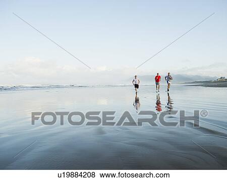 Men running on beach View Large Photo Image Stock Photo - Men running on beach. Fotosearch