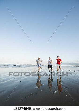 Men running on beach View Large Photo Image Stock Photo - Men running on beach. Fotosearch