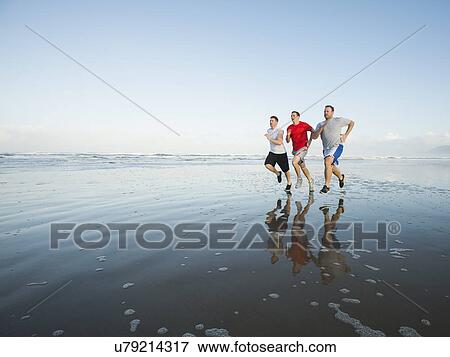 Men running on beach View Large Photo Image Stock Photo - Men running on beach. Fotosearch