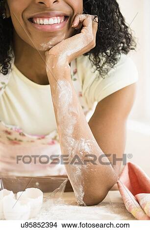 Mid section of woman covered with flour View Large Photo Image Picture - Mid section of woman covered with flour. Fotosearch