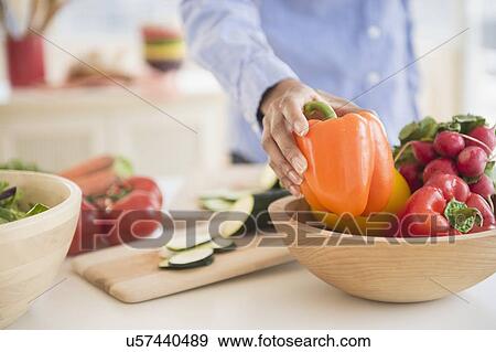 Mid section of woman holding pepper View Large Photo Image Stock Photo - Mid section of woman holding pepper. Fotosearch