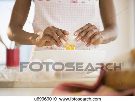Mid section of woman separating eggs View Large Photo Image Stock Image - Mid section of woman separating eggs. Fotosearch