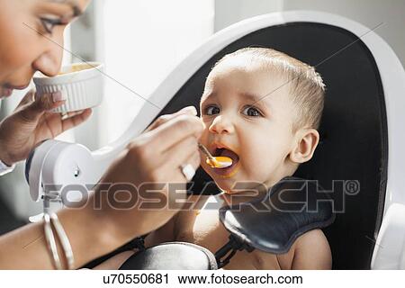 Mother feeding baby (2-5 moths) View Large Photo Image Stock Image - Mother feeding baby (2-5 moths). Fotosearch