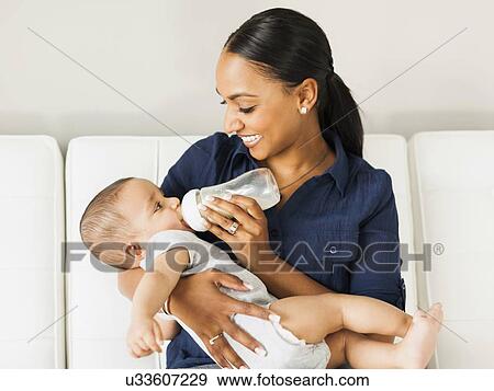 Mother feeding baby (2-5 moths) View Large Photo Image Stock Photo - Mother feeding baby (2-5 moths). Fotosearch