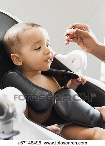 Mother feeding baby (2-5 moths) View Large Photo Image Stock Photograph - Mother feeding baby (2-5 moths). Fotosearch