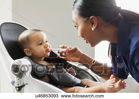 Mother giving medicine to baby (2-5 moths) View Large Photo Image Stock Image - Mother giving medicine to baby (2-5 moths). Fotosearch