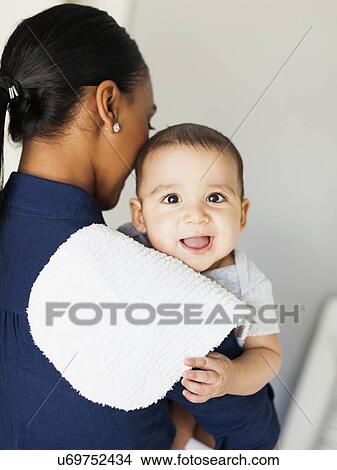 Mother holding baby boy (2-5 moths) View Large Photo Image Picture - Mother holding baby boy (2-5 moths). Fotosearch