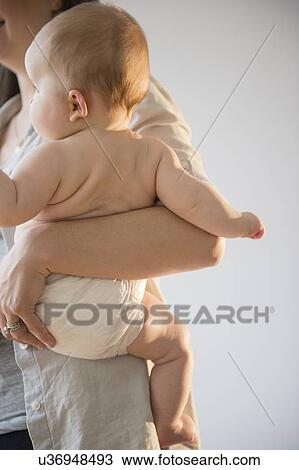 Mother holding baby girl (6-11 months) View Large Photo Image Stock Image - Mother holding baby girl (6-11 months). Fotosearch