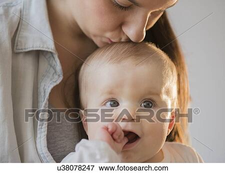 Mother kissing baby daughter (6-11 months) View Large Photo Image Stock Photo - Mother kissing baby daughter (6-11 months). Fotosearch
