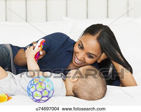 Mother playing with her son (2-5 months) View Large Photo Image Picture - Mother playing with her son (2-5 months). Fotosearch
