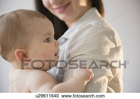 Mother with baby daughter (6-11 months) View Large Photo Image Stock Image - Mother with baby daughter (6-11 months). Fotosearch