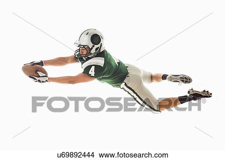 Portrait of American football player catching ball View Large Photo Image Picture - Portrait of American football player catching ball. Fotosearch