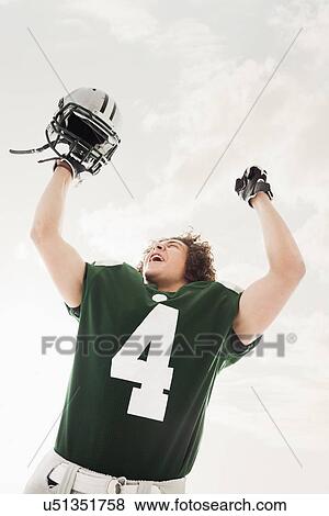 Stock Photo - Portrait of American football player celebrating victory. Fotosearch