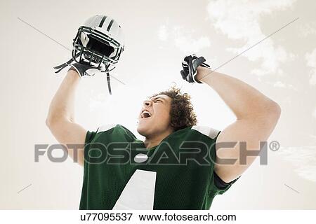 Portrait of American football player celebrating victory View Large Photo Image Stock Photo - Portrait of American football player celebrating victory. Fotosearch