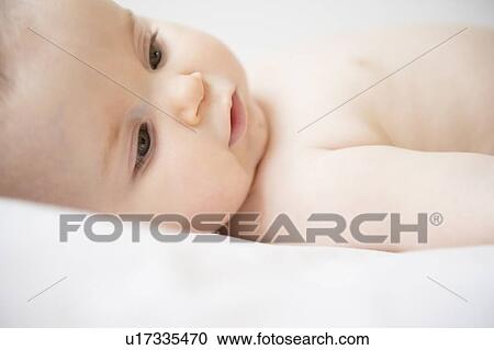 Portrait of baby girl (6-11 months) lying down View Large Photo Image Stock Image - Portrait of baby girl (6-11 months) lying down. Fotosearch