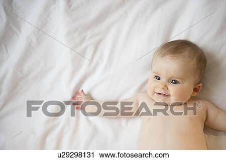 Portrait of baby girl (6-11 months) lying down View Large Photo Image Stock Image - Portrait of baby girl (6-11 months) lying down. Fotosearch