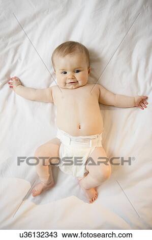 Portrait of baby girl (6-11 months) lying down View Large Photo Image Stock Image - Portrait of baby girl (6-11 months) lying down. Fotosearch