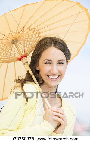 Portrait of beautiful young woman with parasol View Large Photo Image Stock Photo - Portrait of beautiful young woman with parasol. Fotosearch