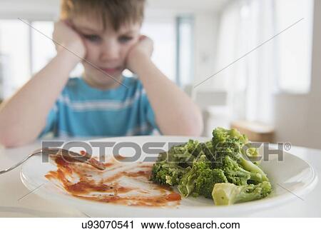 Portrait of boy (4-5) annoyed to eat broccoli View Large Photo Image Stock Image - Portrait of boy (4-5) annoyed to eat broccoli. Fotosearch
