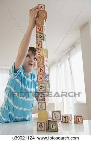 Portrait of boy (4-5) building tower View Large Photo Image Picture - Portrait of boy (4-5) building tower. Fotosearch