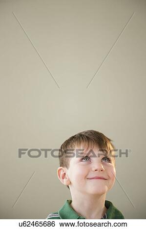 Portrait of boy (4-5) daydreaming View Large Photo Image Stock Photograph - Portrait of boy (4-5) daydreaming. Fotosearch