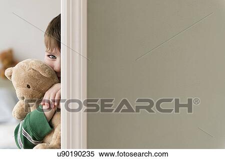 Portrait of boy (4-5) hiding behind wall View Large Photo Image Stock Photography - Portrait of boy (4-5) hiding behind wall. Fotosearch