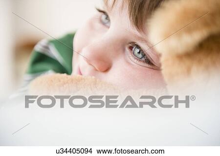 Portrait of boy (4-5) snuggling to teddy bear View Large Photo Image Picture - Portrait of boy (4-5) snuggling to teddy bear. Fotosearch