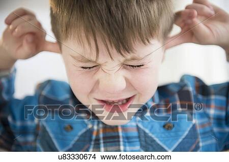 Portrait of boy (4-5) sticking fingers in his ears View Large Photo Image Picture - Portrait of boy (4-5) sticking fingers in his ears. Fotosearch