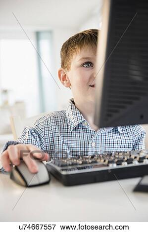 Portrait of boy (4-5) using desktop PC View Large Photo Image Stock Photo - Portrait of boy (4-5) using desktop PC. Fotosearch