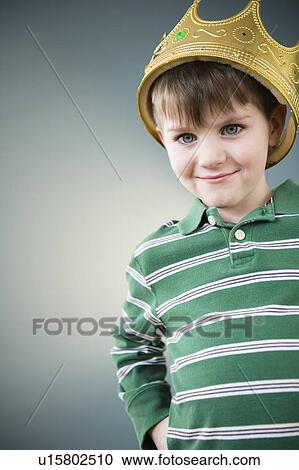 Stock Image - Portrait of boy (4-5) wearing crown. Fotosearch