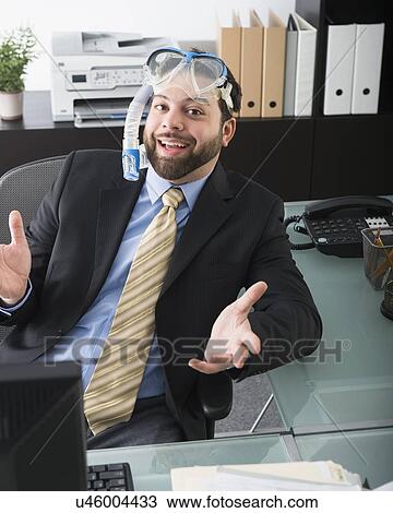 Stock Image - Portrait of businessman dreaming about vacation. Fotosearch