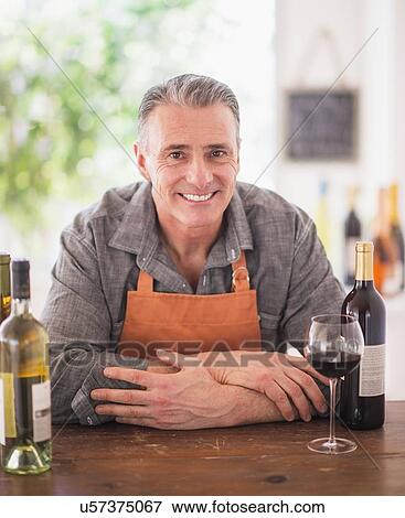 Portrait of cheerful wine store owner View Large Photo Image Stock Photo - Portrait of cheerful wine store owner. Fotosearch