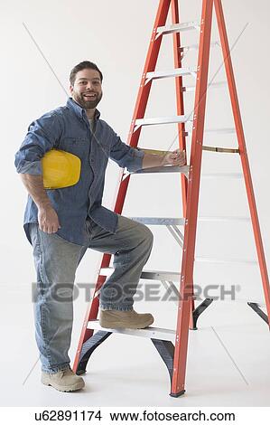 Portrait of construction worker standing by ladder View Large Photo Image Picture - Portrait of construction worker standing by ladder. Fotosearch