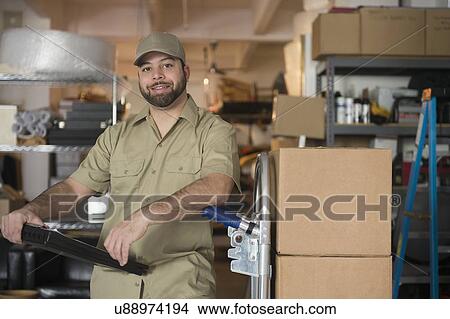Portrait of delivery man in warehouse View Large Photo Image Picture - Portrait of delivery man in warehouse. Fotosearch