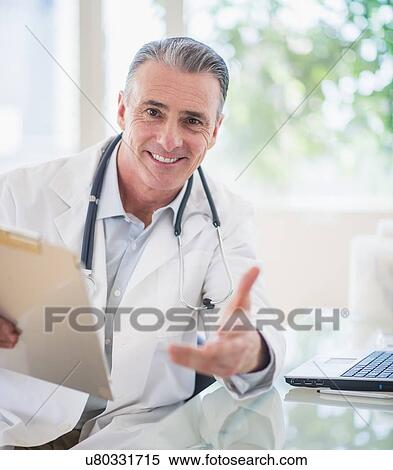 Portrait of doctor in his office View Large Photo Image Stock Photography - Portrait of doctor in his office. Fotosearch