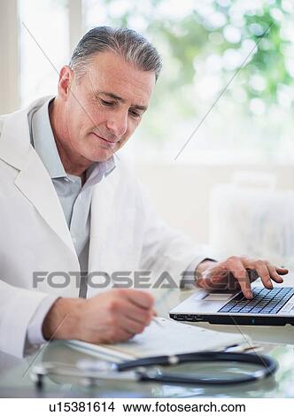 Portrait of doctor working in his office View Large Photo Image Picture - Portrait of doctor working in his office. Fotosearch