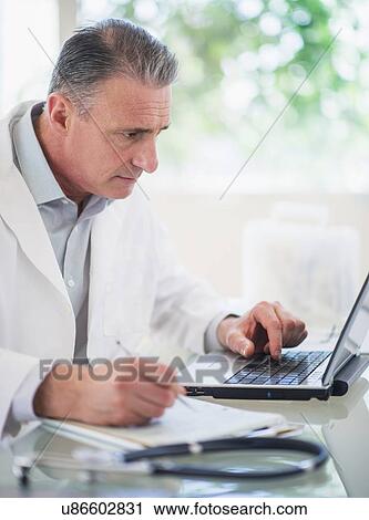 Portrait of doctor working in his office View Large Photo Image Stock Image - Portrait of doctor working in his office. Fotosearch