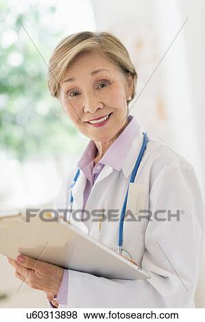 Portrait of female doctor View Large Photo Image Stock Photo - Portrait of female doctor. Fotosearch
