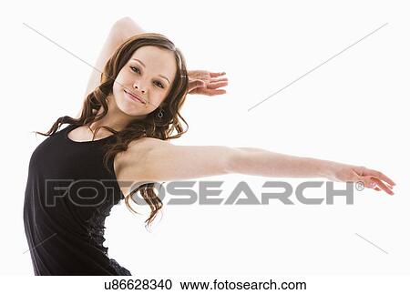 Stock Image - Portrait of girl (12-13) with arms outstretched. Fotosearch
