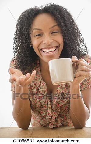 Portrait of happy woman holding coffee cup View Large Photo Image Stock Image - Portrait of happy woman holding coffee cup. Fotosearch