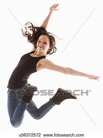 Stock Image - Portrait of jumping girl (12-13). Fotosearch