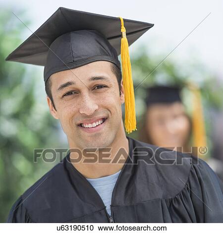 Portrait of male student on graduation ceremony with female student in background View Large Photo Image Stock Image - Portrait of male student on graduation ceremony with female student in background. Fotosearch