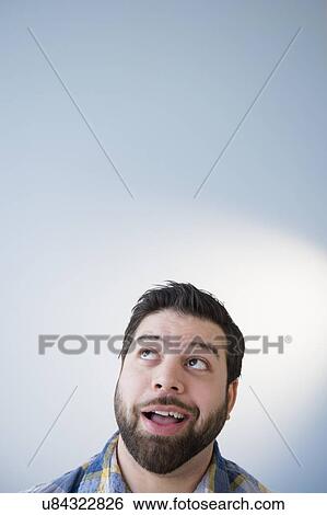 Stock Photograph - Portrait of man daydreaming. Fotosearch