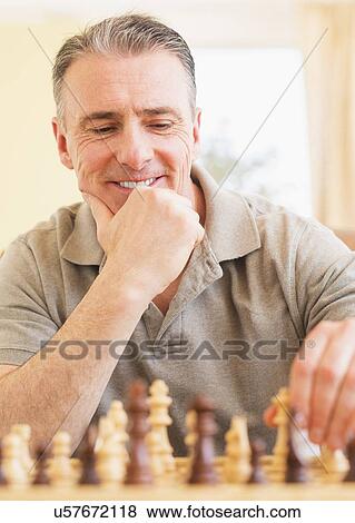 Portrait of man playing chess View Large Photo Image Stock Photo - Portrait of man playing chess. Fotosearch