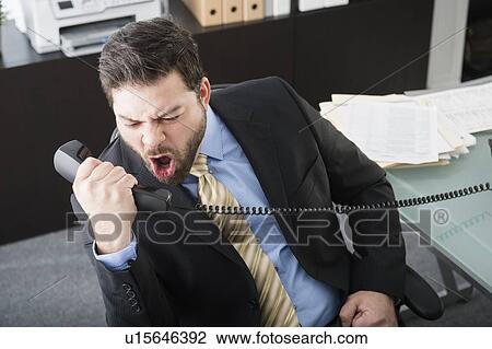 Stock Image - Portrait of man shouting on phone. Fotosearch