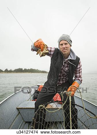 Portrait of man showing crab View Large Photo Image Picture - Portrait of man showing crab. Fotosearch