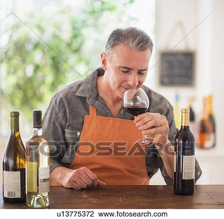 Stock Image - Portrait of man tasting wine. Fotosearch