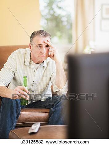 Portrait of man watching tv View Large Photo Image Stock Image - Portrait of man watching tv. Fotosearch