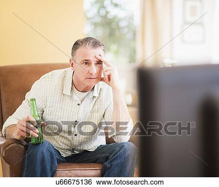 Portrait of man watching tv View Large Photo Image Stock Photograph - Portrait of man watching tv. Fotosearch